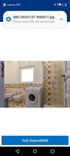 a bathroom with a washing machine in a room at Casa in stile in Pezze di Greco
