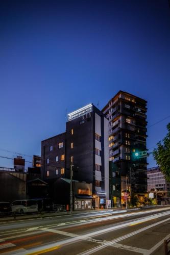 a building on a city street at night at Sauna Hotel Gifu in Gifu