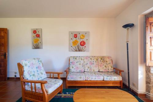 a living room with a couch and a chair at Hotel Casa Rectoral in Tui