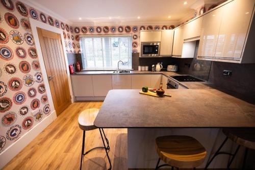 a kitchen with a table and chairs in it at Thistle Lodge in Comrie