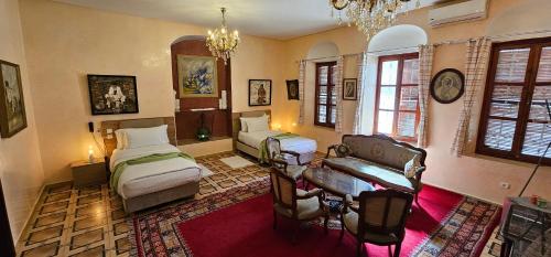 a bedroom with two beds and a desk and a couch at Ryad 91 in Casablanca