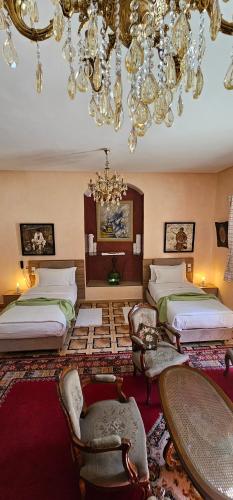 a large room with two beds and a chandelier at Ryad 91 in Casablanca