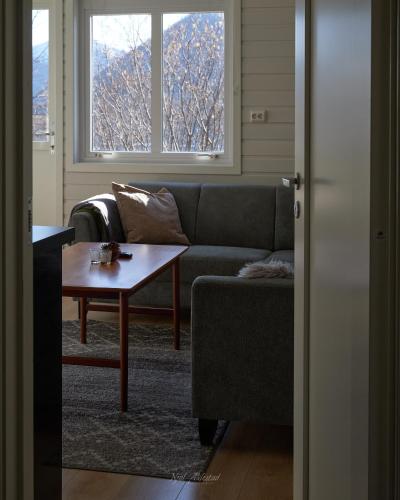 a living room with a couch and a coffee table at Rjånes Ferie og Konferansesenter in Ørsta