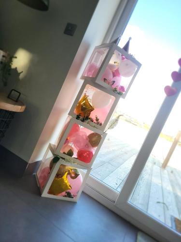 a shelf with three tiers ofartmentsigunigunigunigunigunigunigunigunigun at Luxurious and Peaceful Lakeside House, Clitheroe in Clitheroe