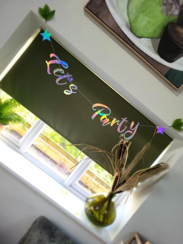 a window with a sign that reads happy birthday at Luxurious and Peaceful Lakeside House, Clitheroe in Clitheroe