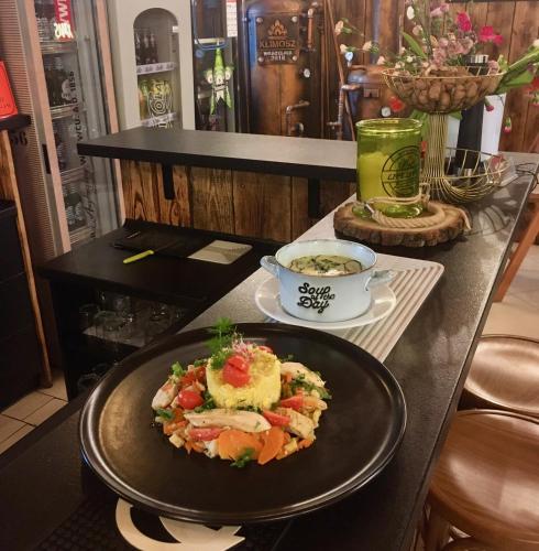 a black table with a plate of food on it at Pokoje Gościnne u Klimosza in Pogwizdów