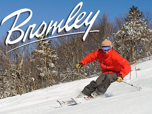 a man is skiing down a snow covered slope at Snowdon Chalet Motel in Londonderry