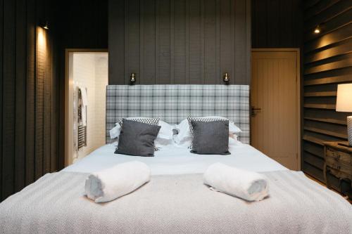 a bedroom with a large bed with two towels on it at Retreat East in Ipswich