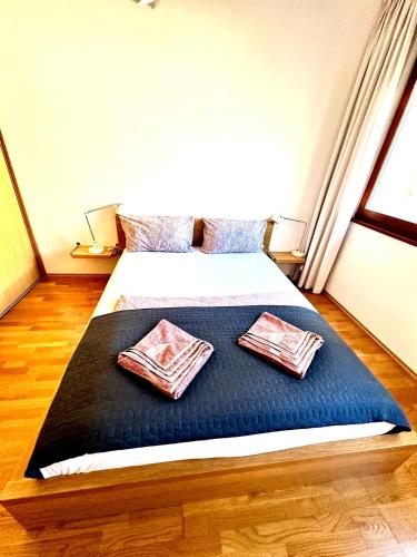 a bedroom with a bed with two pillows on it at Central apartment with balcony in Budapest