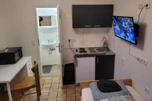 a small room with a kitchen and a bed in it at idylischer Bachplatz in Oerlinghausen