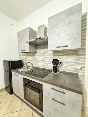 a kitchen with a sink and a counter top at CyO Apartment 2 in Boscotrecase