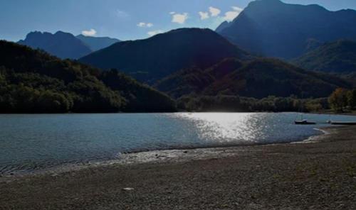 a body of water with mountains in the background at Villa with panoramic views at Minucciano ! in Magliano