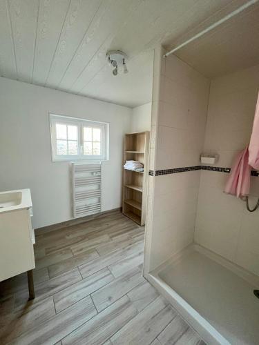 une salle de bain avec une douche avec une porte vitrée dans l'établissement le relais de l'abbaye, à Jumièges