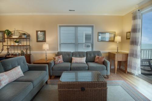 a living room with a couch and a table at Seaside Villas II in Folly Beach