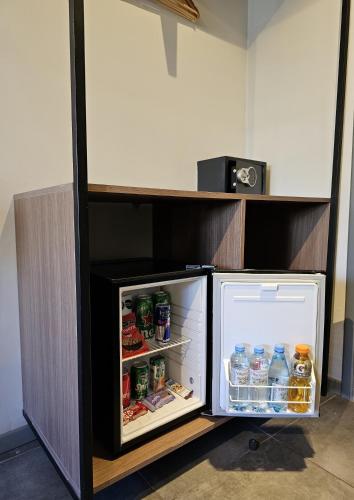 a small refrigerator with its door open in a room at HOTEL CONCEPT BARILOCHE in San Carlos de Bariloche