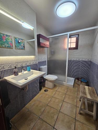 a bathroom with a sink and a toilet at Casalegre in El Cotillo