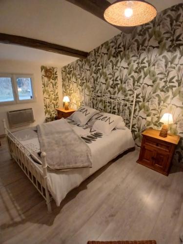 une chambre avec un lit avec un papier peint fleuri dans l'établissement Maison de plein pied avec vue sur le Lubéron, à Maubec