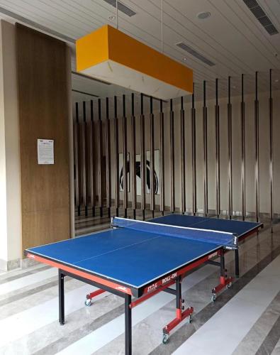 a ping pong table in a tennis court at Rizz Stay in Lucknow