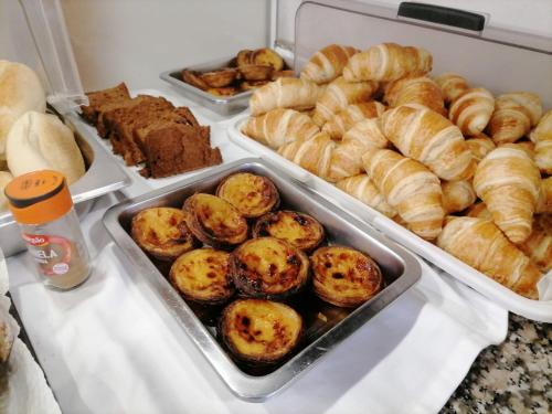 a refrigerator filled with trays of pastries and other foods at O Vicente in Loriga