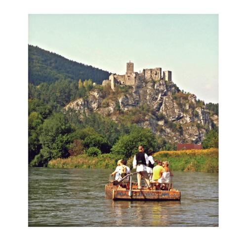 a group of people on a raft in a river with a castle at Rekreacny Dom in Strečno