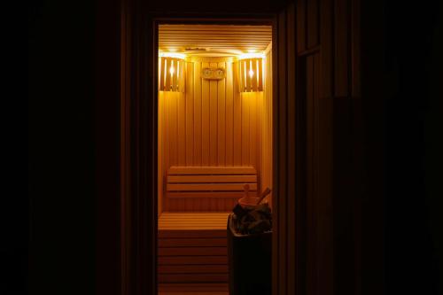 a door leading to a room with a chair and lights at Radisson Hotel & Residence Riyadh Olaya in Riyadh