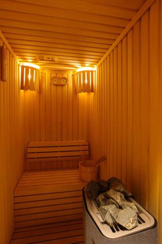 a small sauna with a bench and a trash can at Radisson Hotel & Residence Riyadh Olaya in Riyadh