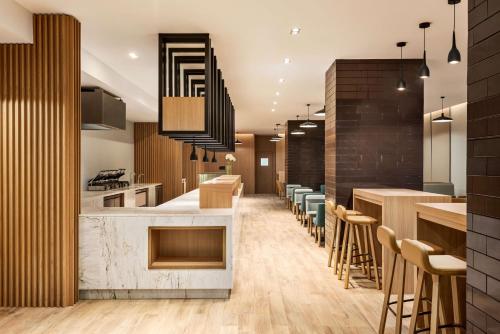 a restaurant with a bar with stools at Radisson Hotel & Residence Riyadh Olaya in Riyadh