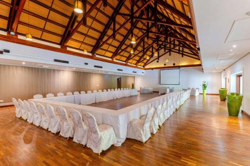 a large conference room with a long table and chairs at Crystals Beach Resort Belle Mare, a member of Radisson Individuals in Belle Mare