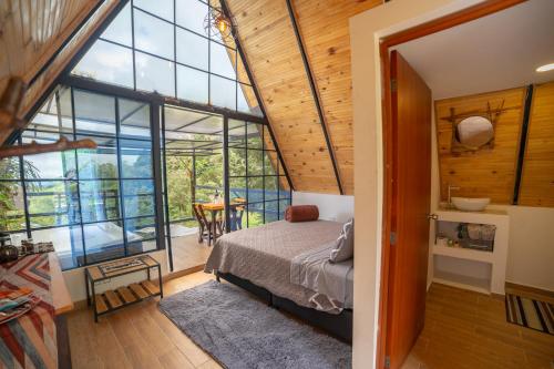 a bedroom with a bed and a large window at Kavas Natural Connection in Salento