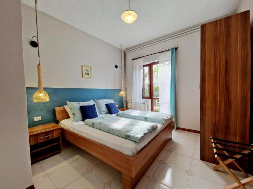 a bedroom with a bed and a window at Poreč RUSTICO MEDITERRANEO Apartment with a large terrace by Villa Mihaela in Poreč