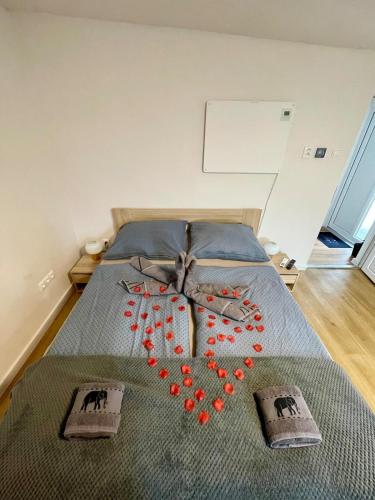 a bed with a heart made out of red beads at Apartment house close to Bojnice in Prievidza