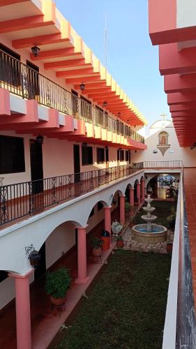 a large building with a courtyard with a fountain at Hotel Zaci in Valladolid