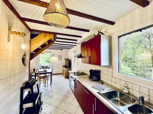 une cuisine avec un évier et un plan de travail dans l'établissement Pré Ferry - gîte au coeur de la nature, à Gérardmer