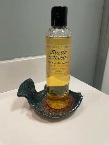 a bottle of whisky sitting on a plate at Route3BnB in Shag Harbour