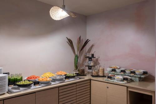 a buffet line with many different types of food at Novotel Bogota Parque 93 in Bogotá
