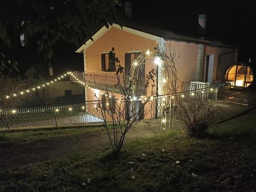 a house with lights on a fence at night at Villa Sumbilla, Modern, with sauna, heated jacuzzi near Tuscany in Monghidoro