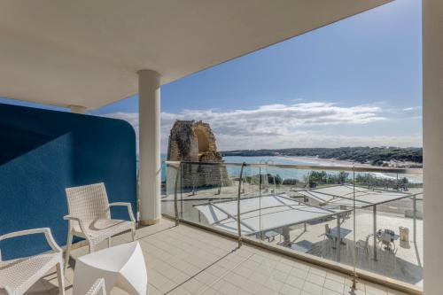 a balcony with chairs and a view of the ocean at Hotel Belvedere in Torre dell'Orso
