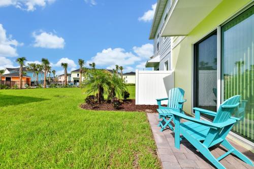 a pair of blue chairs sitting on the porch of a house at Margaritaville Cottages Orlando with H2O Waterpark by Rentyl in Kissimmee