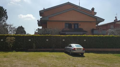 a car parked in front of a house at Aurelia Garden Gold B&B in Rome