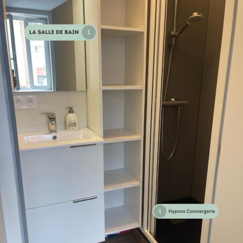 une salle de bain avec un lavabo et une douche dans l'établissement Le Premier Pas, départ du Saint Jacques, au Puy-en-Velay