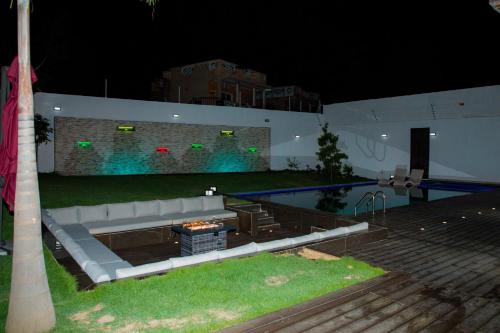 a swimming pool at night with a couch next to it at Villa Palm évasion in Ngaparou