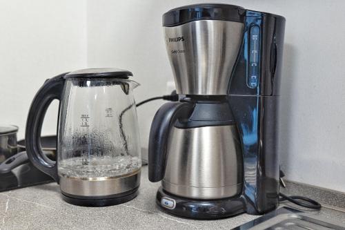 a blender sitting on a counter next to a container at Stuttgart City Apartment A in Stuttgart