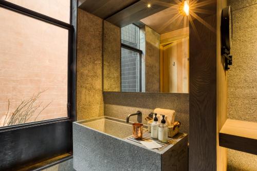 a bathroom with a sink and a mirror at Casa Tenue in Mexico City