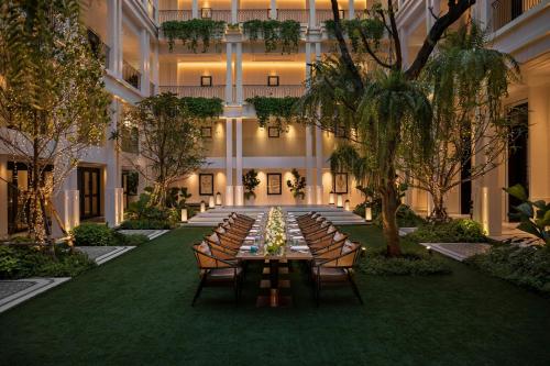 a long table with chairs in the middle of a building at Bangkok Marriott Hotel The Surawongse in Bangkok