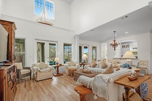 a large living room with white furniture and windows at Blue Bayou in Gulf Highlands