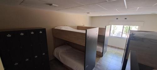 a room with two bunk beds and a window at Alojamiento Traslaviña in Vista Flores