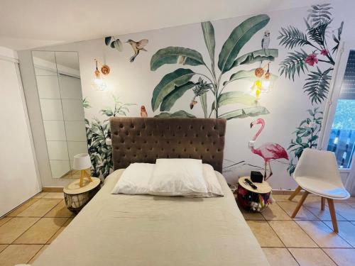 - une chambre avec un lit et une fresque murale au flamant dans l'établissement Villa Zanzibar Porto-vecchio, à Porto-Vecchio