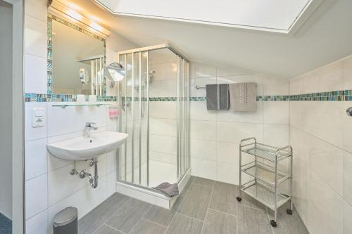 a bathroom with a sink and a shower at Gästehaus Sonnenbichl in Berchtesgaden