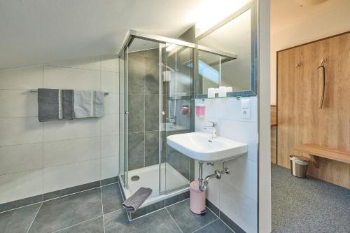 a bathroom with a sink and a shower at Gästehaus Sonnenbichl in Berchtesgaden
