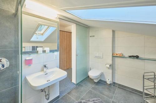 a bathroom with a sink and a toilet at Gästehaus Sonnenbichl in Berchtesgaden